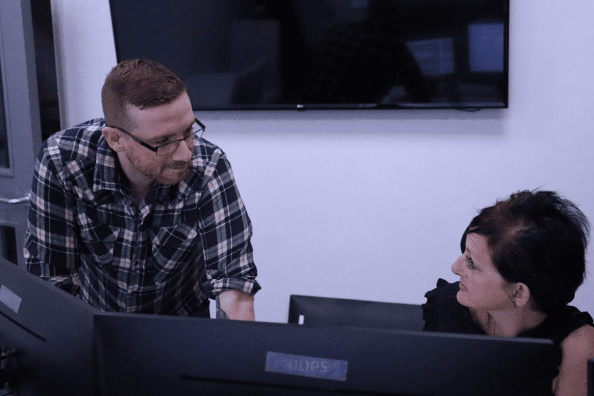 Two colleagues going over figures on screen together